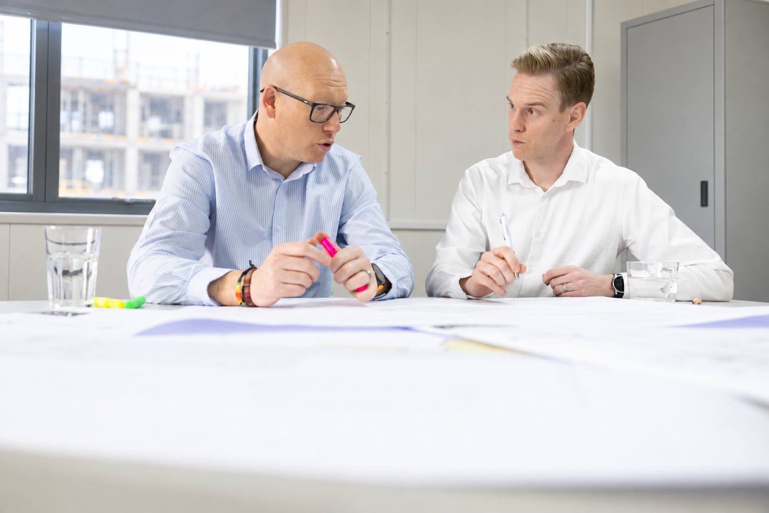 W2 consultants reviewing documents together at a working meeting